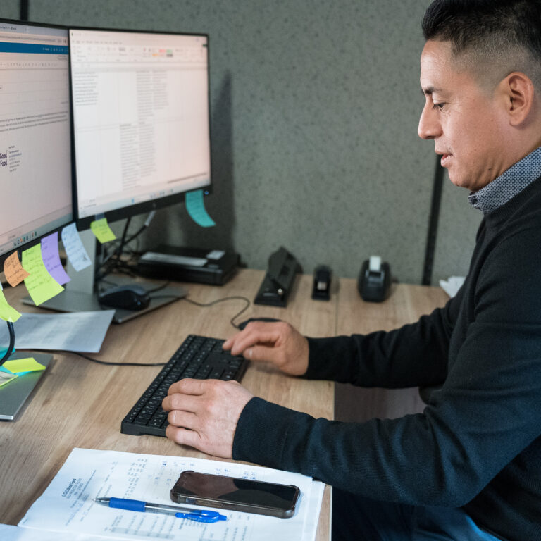 An image of CKC staff member typing at a computer