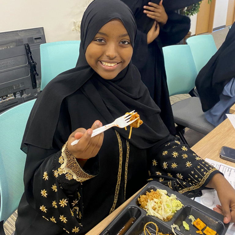 Student from Twin Cities International participating in spring taste test event