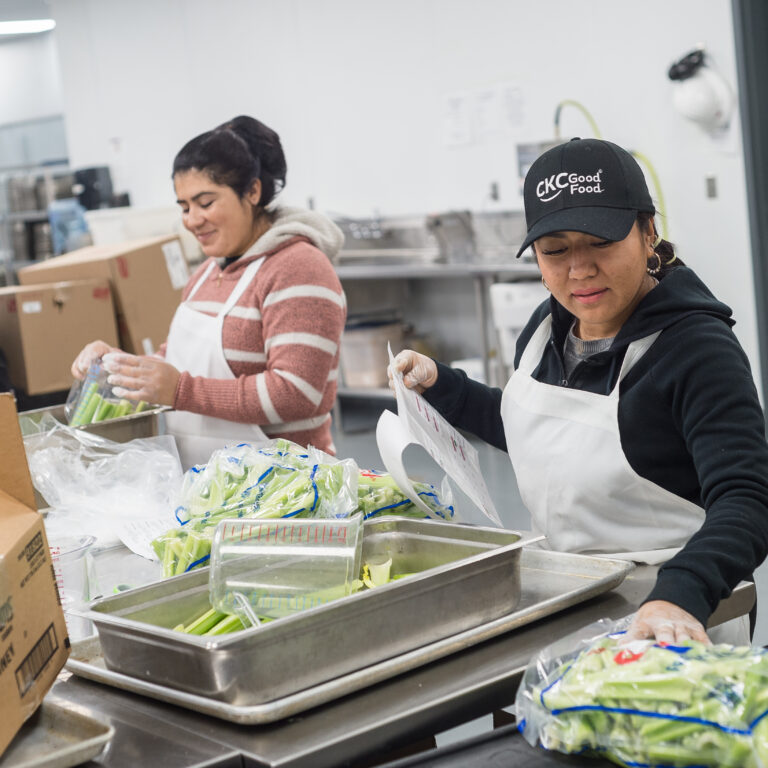 Food service team members portioning fresh produce