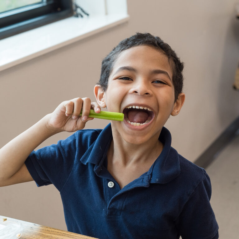 Young boy chomping celery