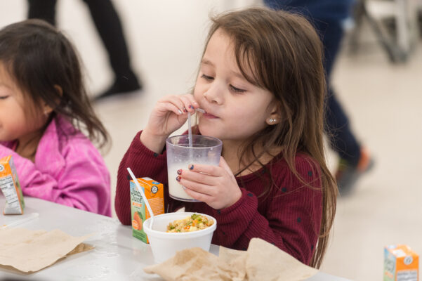 Young girl drinking milk thru a straw