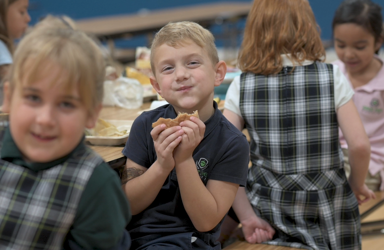 Smiling young boy holding food